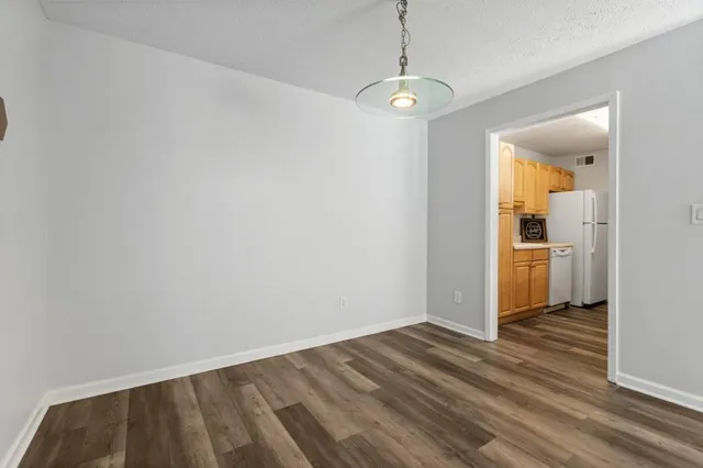 a view of a kitchen with wooden floor and a sink