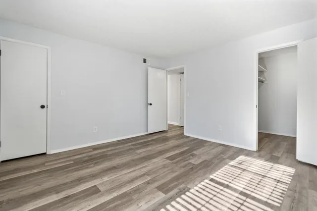 a view of walk in closet with empty racks