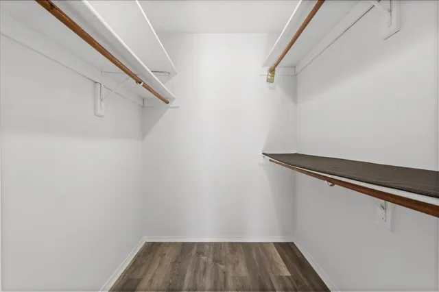 a bathroom with a sink a toilet a large mirror and shower