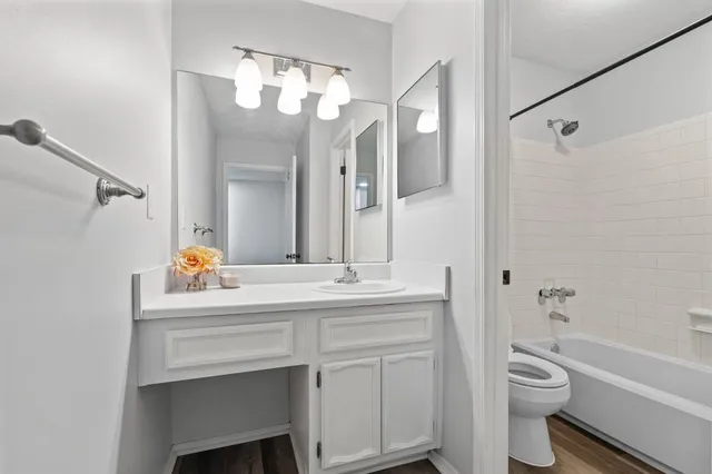 a white bath tub sitting next to a white toilet