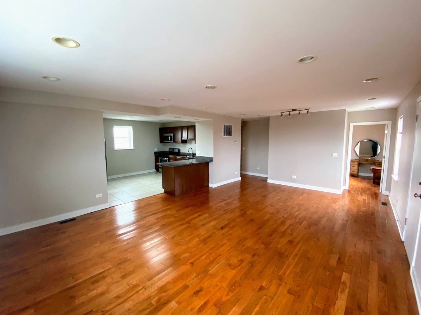 2245 West 21st Street, Unit 4 Chicago, IL 60608 - Photo 3 of 16 a living room with hard wood floors and a kitchen