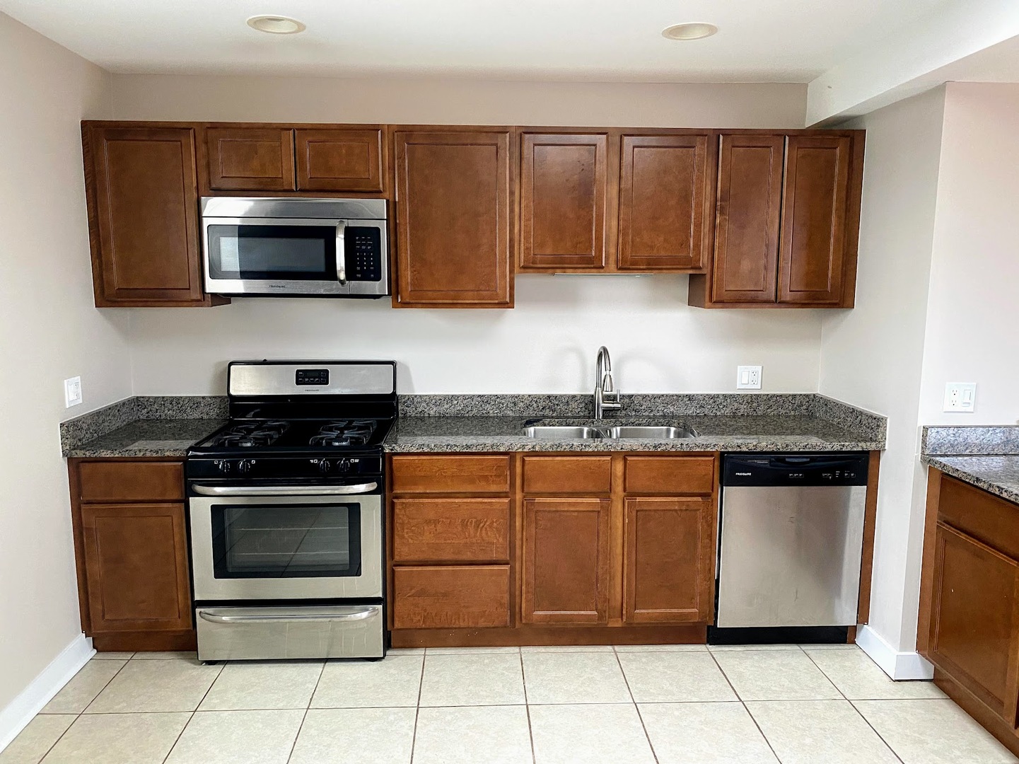 2245 West 21st Street, Unit 4 Chicago, IL 60608 - Photo 4 of 16 a kitchen with stainless steel appliances granite countertop a stove a microwave and a sink