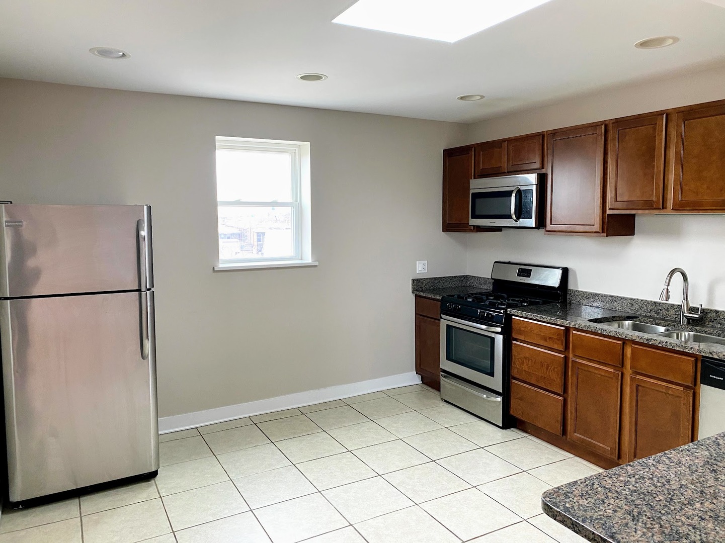 2245 West 21st Street, Unit 4 Chicago, IL 60608 - Photo 5 of 16 a kitchen with stainless steel appliances granite countertop a refrigerator stove top oven and sink