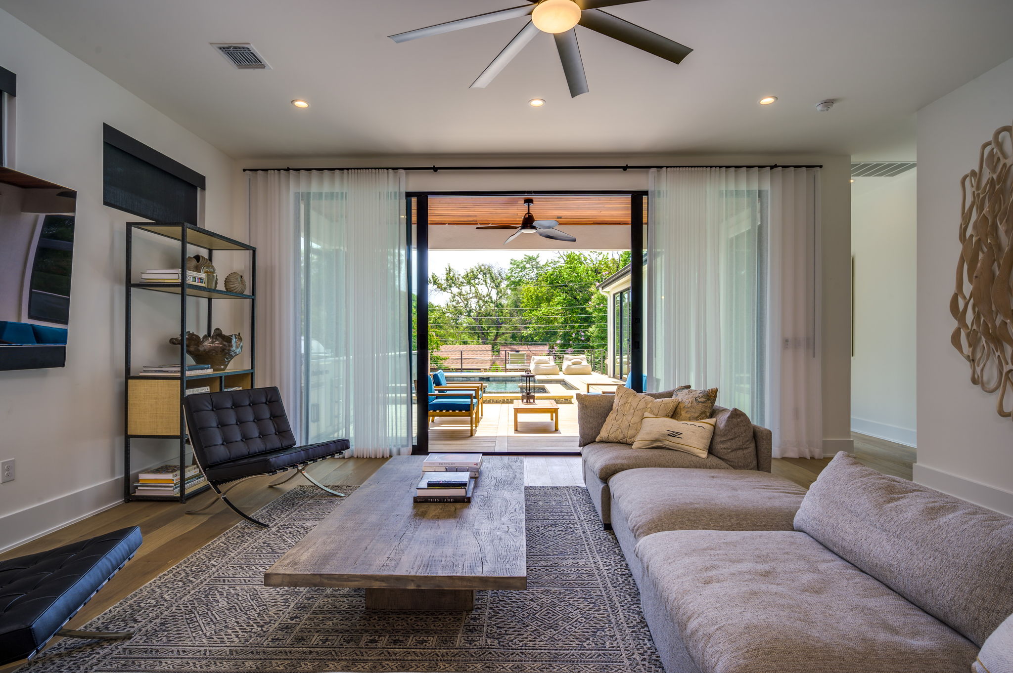 2415 McCall Road Austin, TX 78703 - Photo 18 of 40 Sliding glass doors reveal an inviting outdoor area with a refreshing pool.