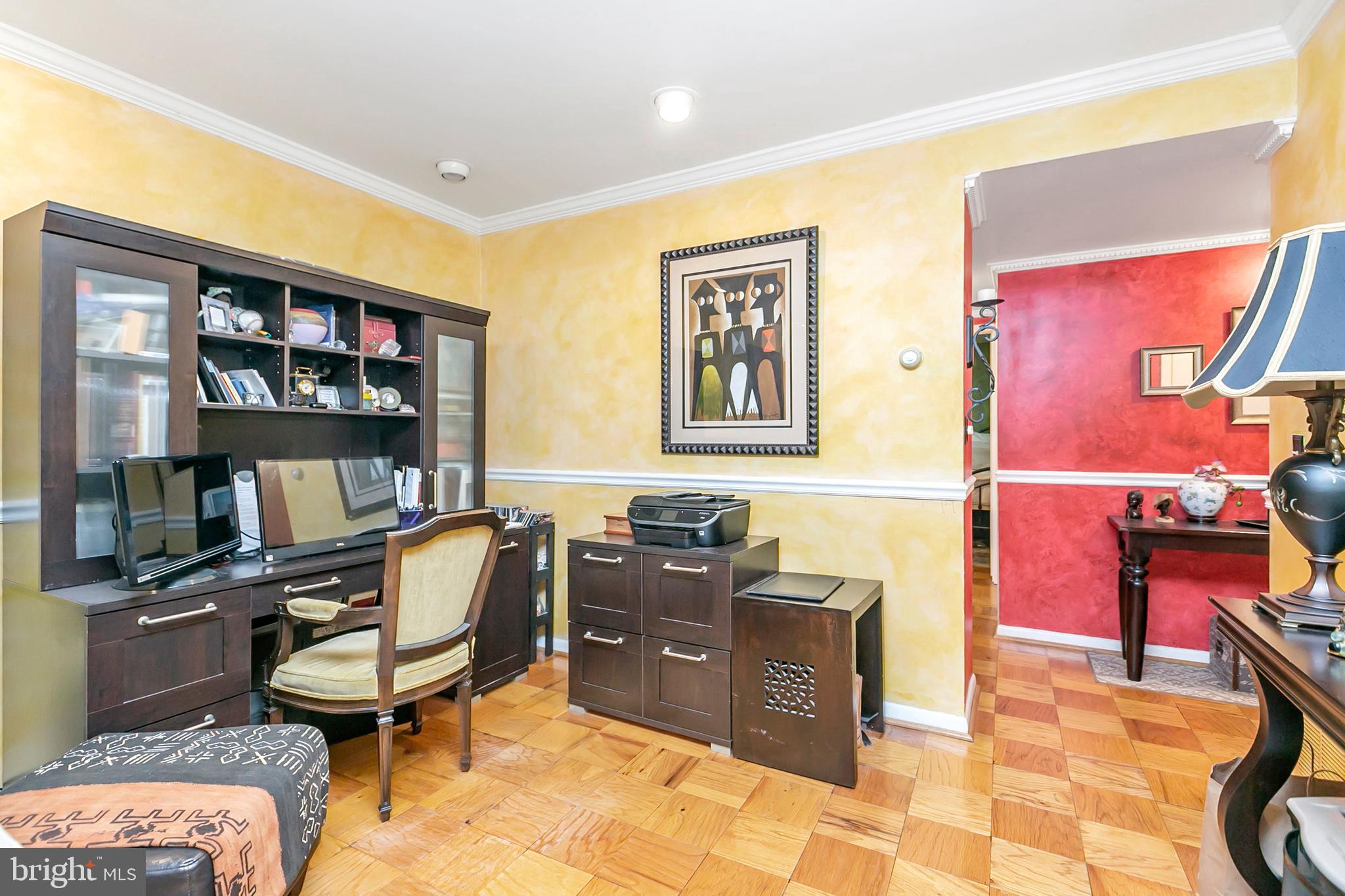 111 Cross Keys Road, Unit R111D Baltimore, MD 21210 - Photo 5 of 15 Living room features crown molding and chair rail