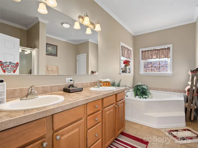 a bathroom with a granite countertop sink a large mirror and a shower