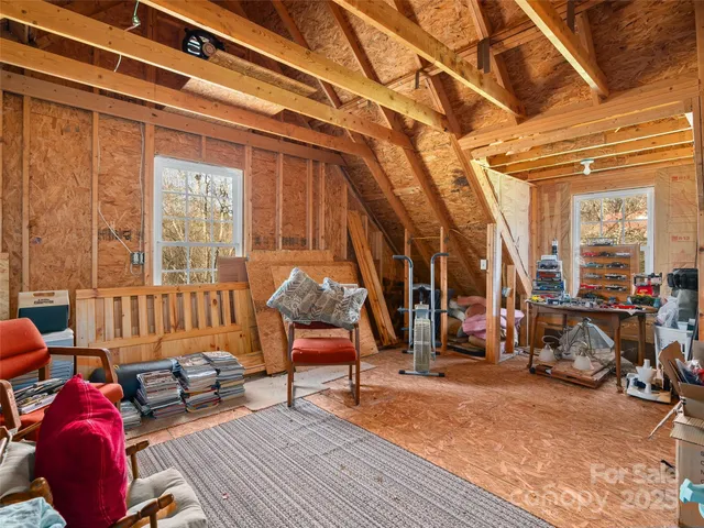 a living room with furniture a wooden floor and a large window