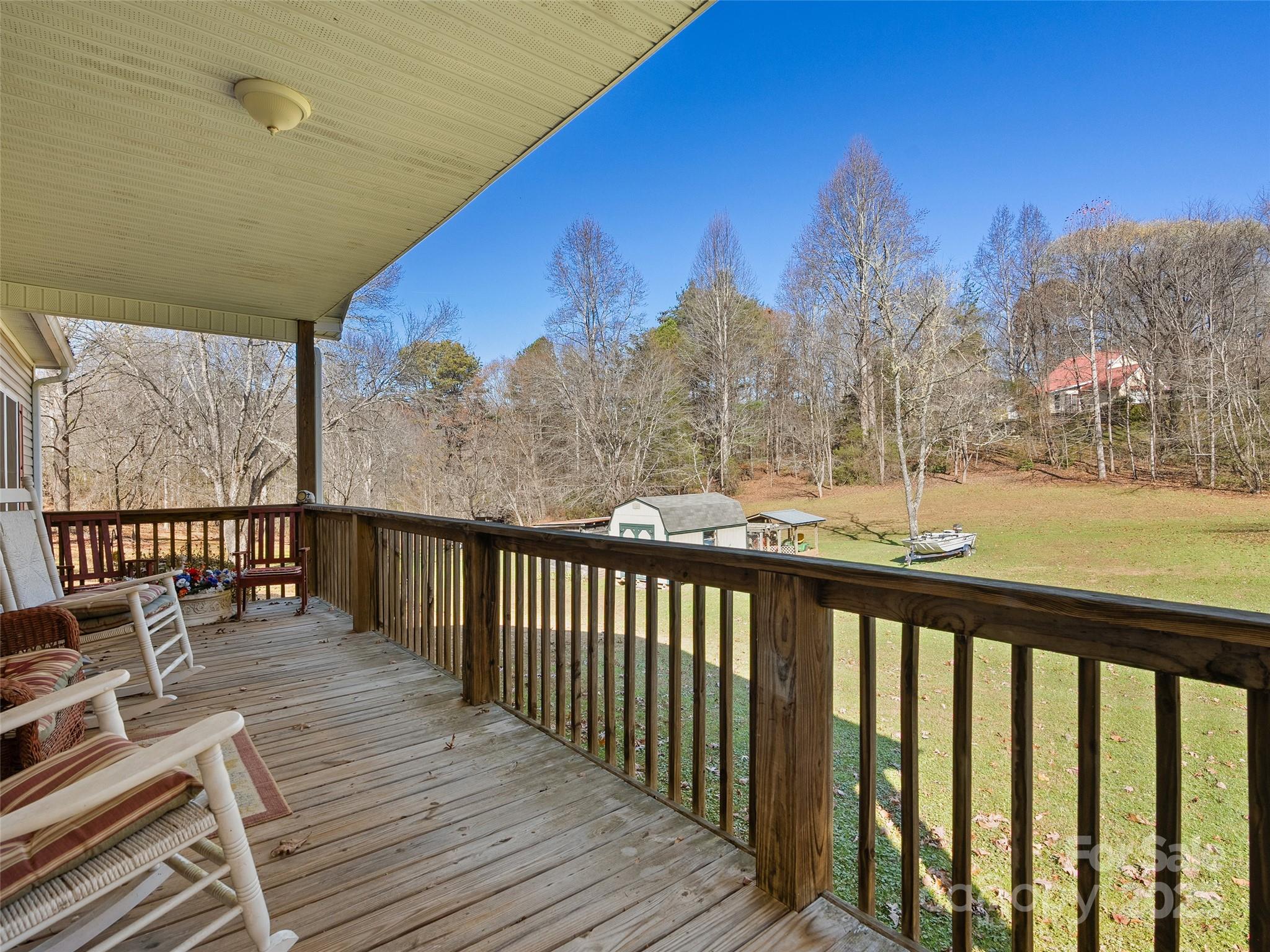 70 Pierce Elders Road Whittier, NC 28789 - Photo 3 of 36 a view of a balcony with wooden floor & fence