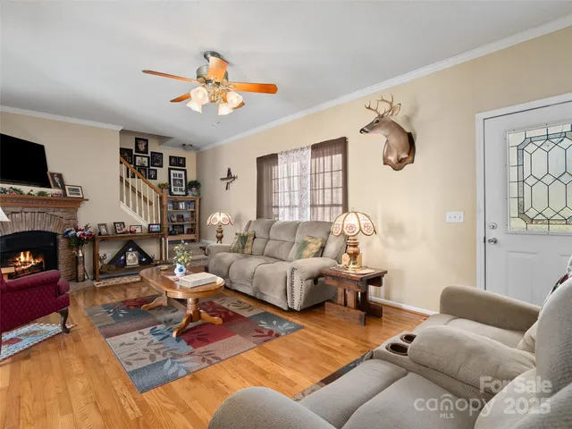 a living room with furniture a fireplace and a flat screen tv