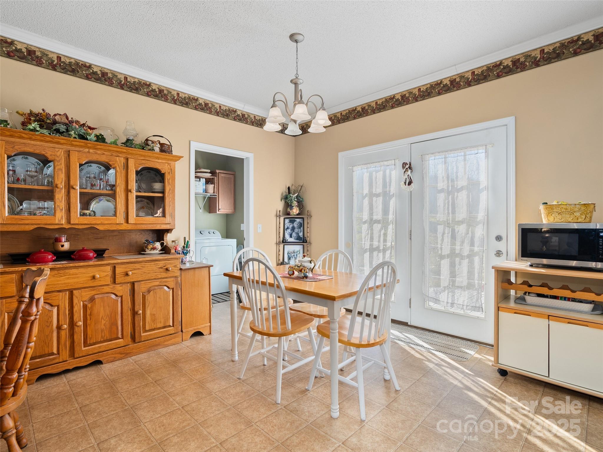 70 Pierce Elders Road Whittier, NC 28789 - Photo 8 of 36 a view of a dining room with furniture chandelier and wooden floor