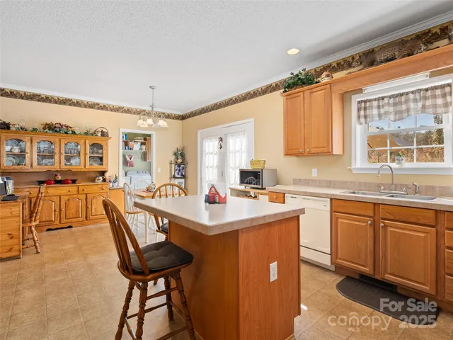 a kitchen that has a lot of cabinets in it and appliances