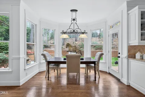 a kitchen with stainless steel appliances granite countertop a stove top oven a refrigerator a sink and a island