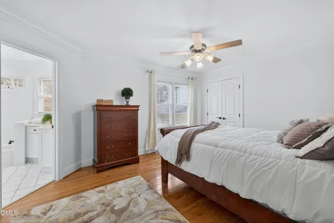 a living room with a bed and a dresser