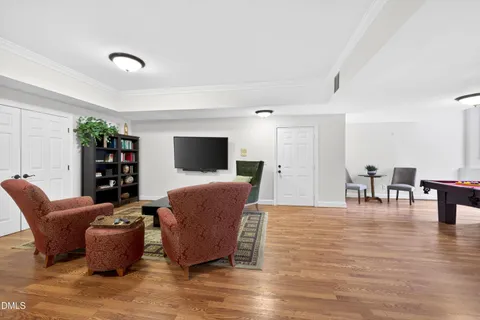 a room with a table chairs and wooden floor