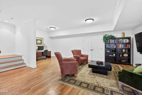 a room with furniture pool table and wooden floor