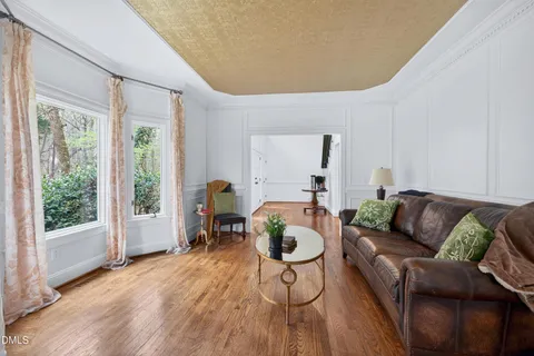 a dining room with wooden floor and furniture