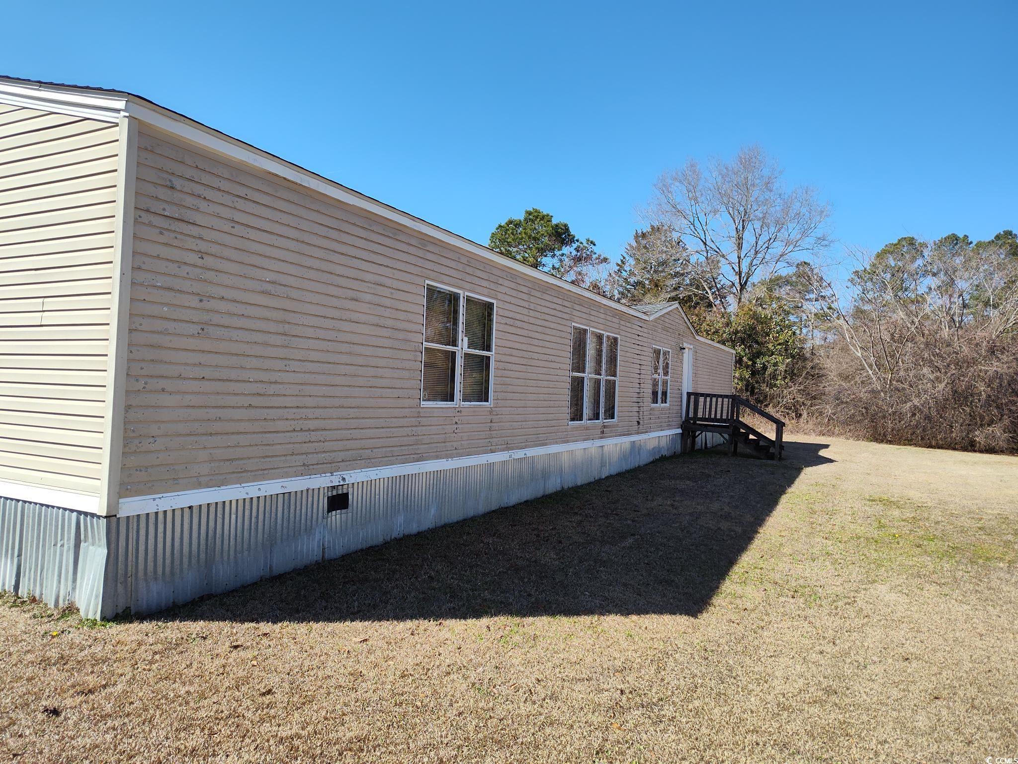 73 Newton Trail Andrews, SC 29510 - Photo 2 of 3 View of home's exterior featuring a lawn