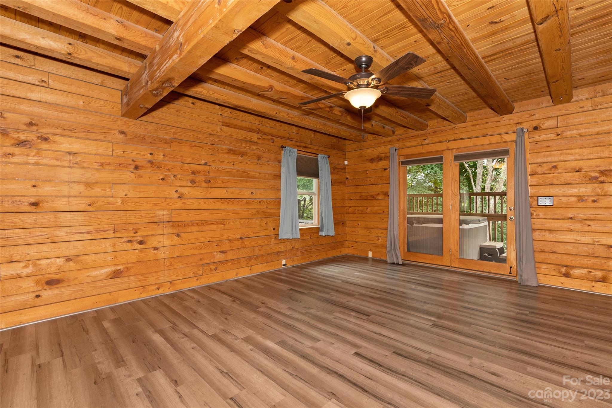 243 Penland Street Clyde, NC 28721 - Photo 14 of 20 a view of an empty room with wooden floor and a window