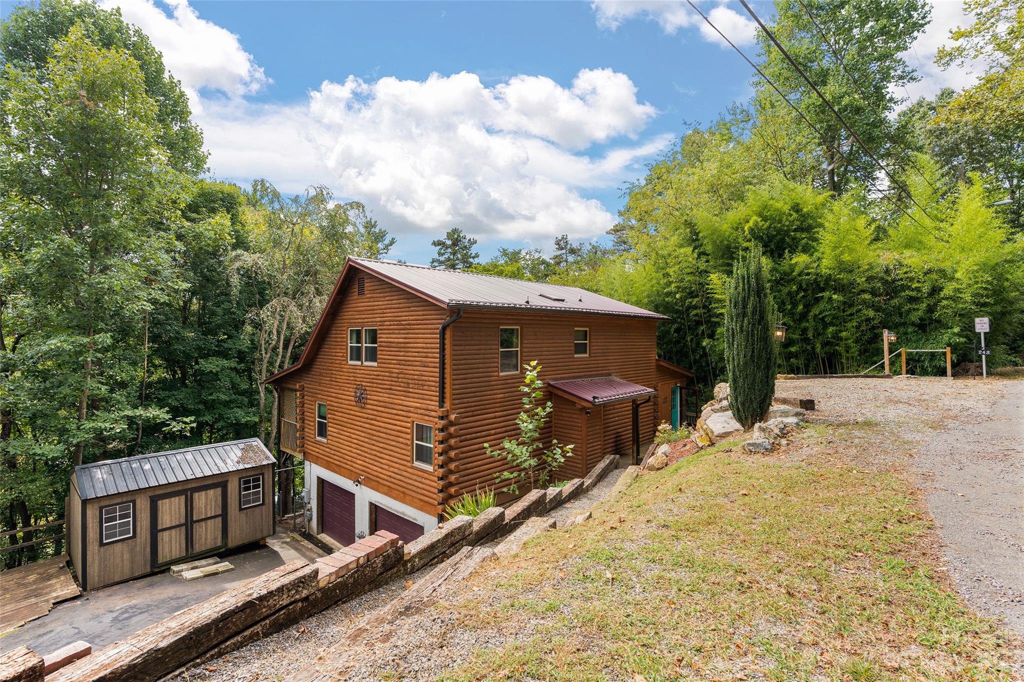 243 Penland Street Clyde, NC 28721 - Photo 2 of 20 a view of a house with wooden fence