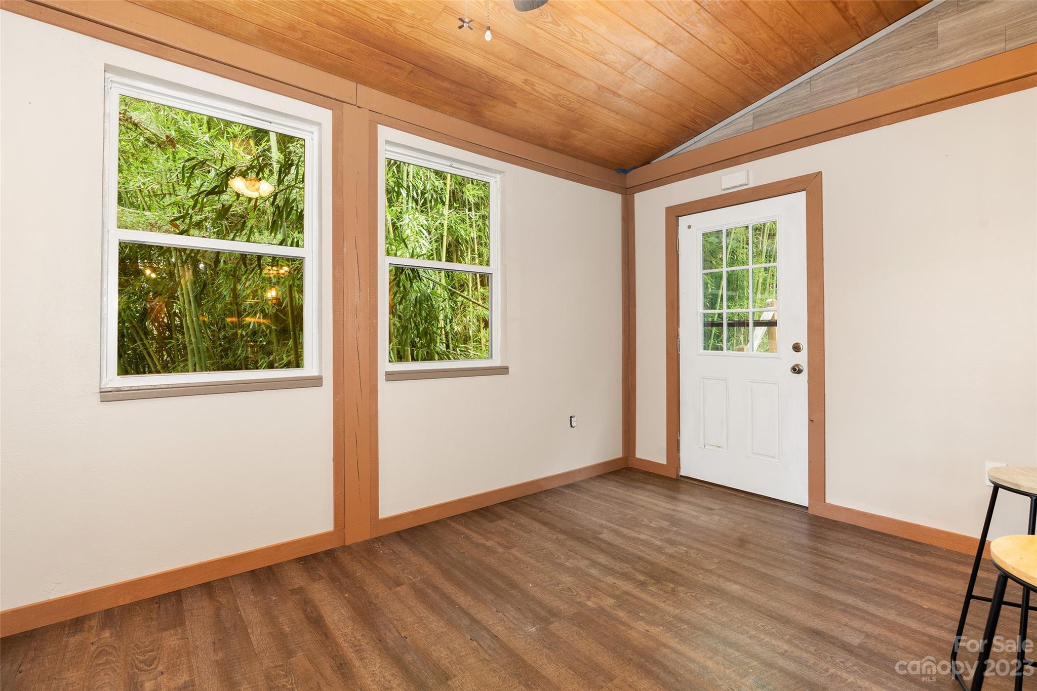 243 Penland Street Clyde, NC 28721 - Photo 4 of 20 an empty room with wooden floor and windows
