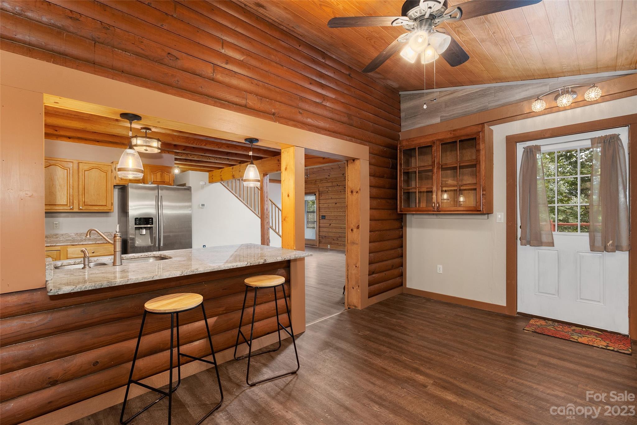 243 Penland Street Clyde, NC 28721 - Photo 5 of 20 a view of a room with wooden floor and ceiling fan