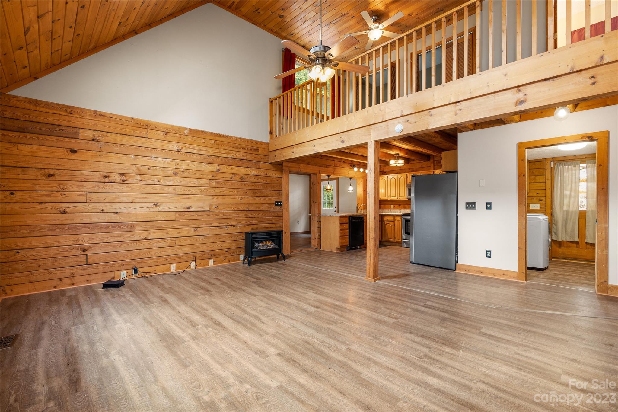 243 Penland Street Clyde, NC 28721 - Photo 9 of 20 an empty room with wooden floor and furniture