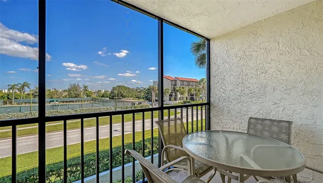 a balcony with furniture and a potted plant