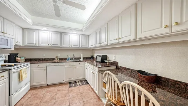 a white refrigerator freezer sitting inside of a kitchen