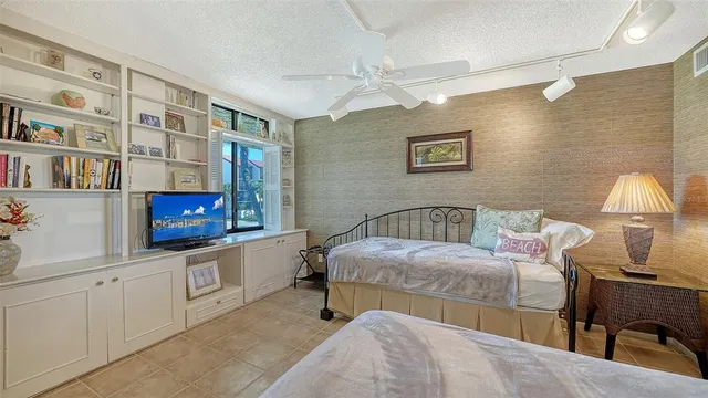 a bedroom with a bed couch and window