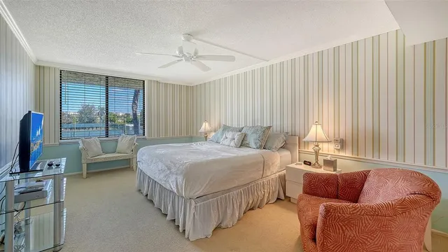 a bedroom with a bed couch and window