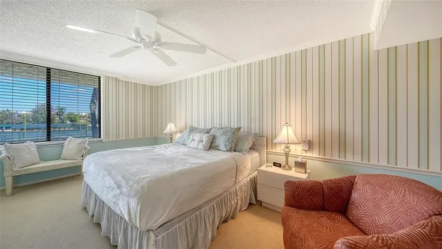 a bed sitting in a bedroom next to a window