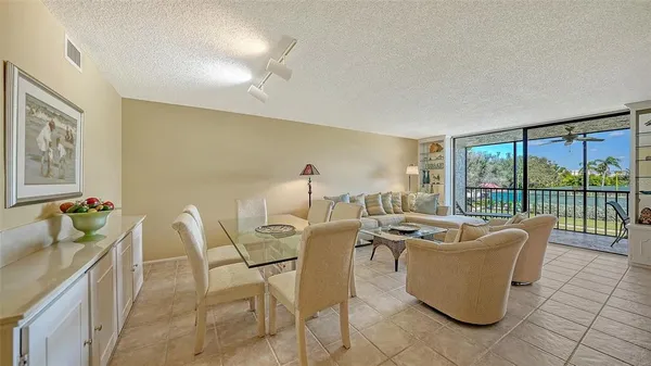 a living room with furniture and a floor to ceiling window