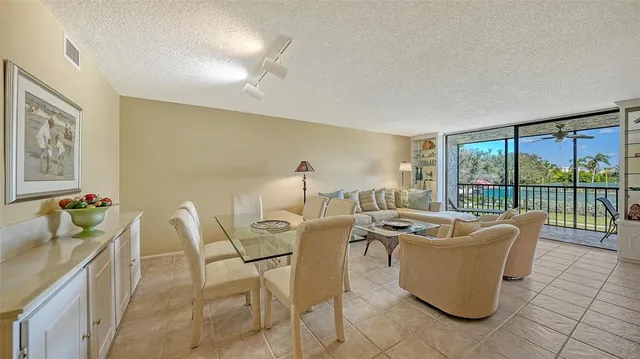 a living room with furniture and a floor to ceiling window