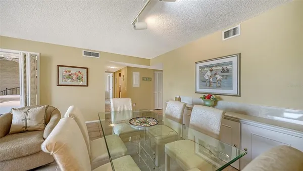 a dining room with furniture and wooden floor