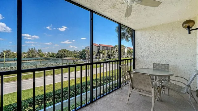 a view of a balcony dining area with furniture