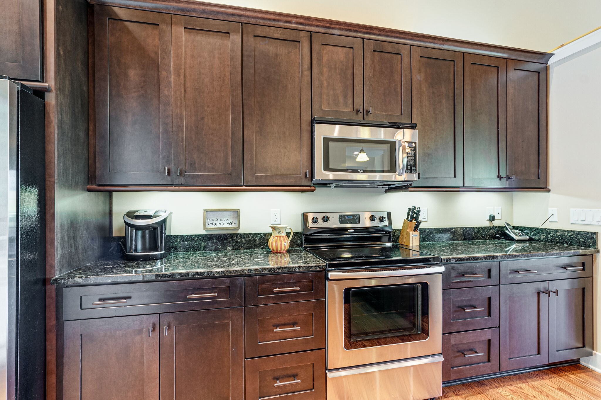 115 Vista Pt Road, Unit 115 Silver Point, TN 38582 - Photo 11 of 50 a kitchen with granite countertop wooden cabinets and stainless steel appliances