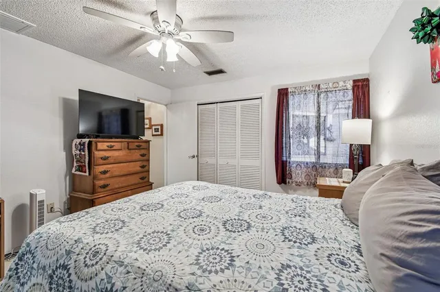 a bedroom with a bed and a television