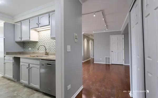 a view of kitchen with granite countertop cabinets stainless steel appliances and a sink
