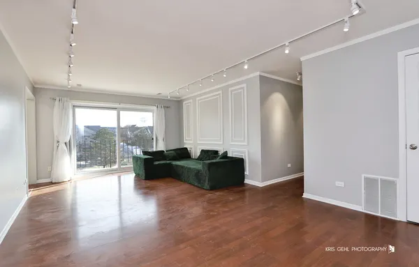 a living room with furniture and wooden floors