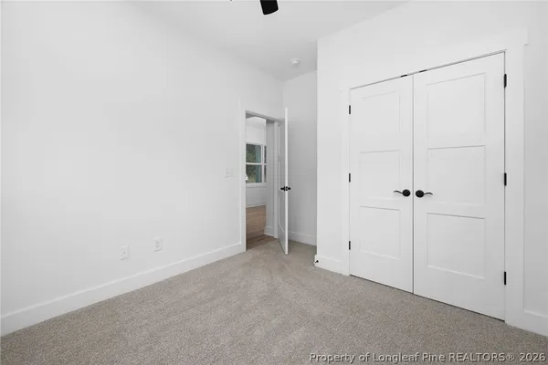 a view of a hallway with wooden floor and entryway