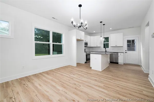 a view of a kitchen with stove and cabinets