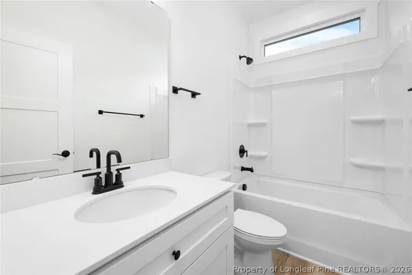 a bathroom with a sink a toilet and a bathtub