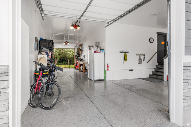 313 Old Maple Road South Weber, UT 84405 - Photo 35 of 35 Spacious garage featuring a durable epoxy floor finish, overhead lighting, and interior access to the property