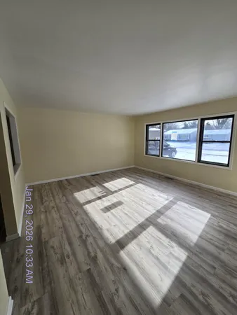 a view of kitchen with microwave stove refrigerator and cabinets