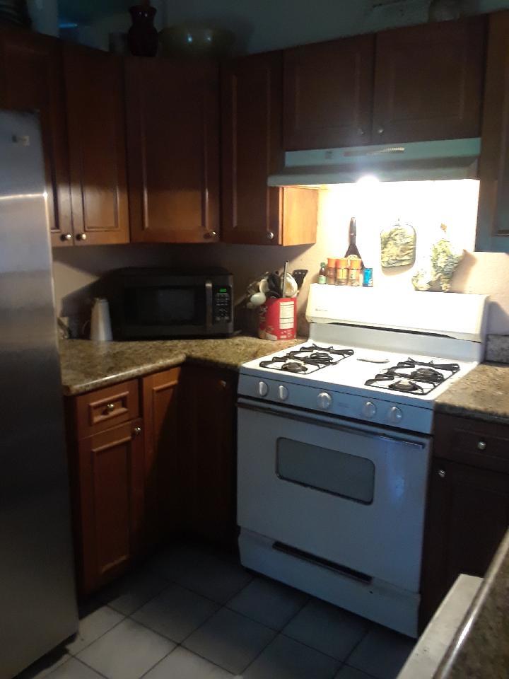 5544 South Rue Road West Palm Beach, FL 33415 - Photo 9 of 14 a stove top oven sitting inside of a kitchen