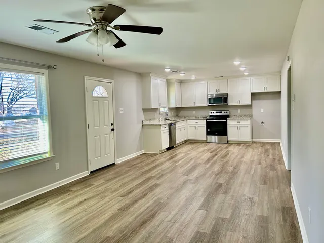 a view of a kitchen with a sink and a refrigerator