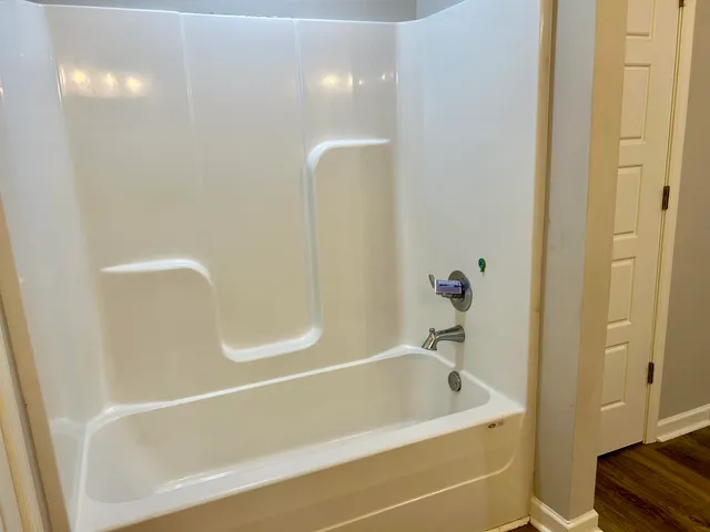a bathroom with a tub and shower