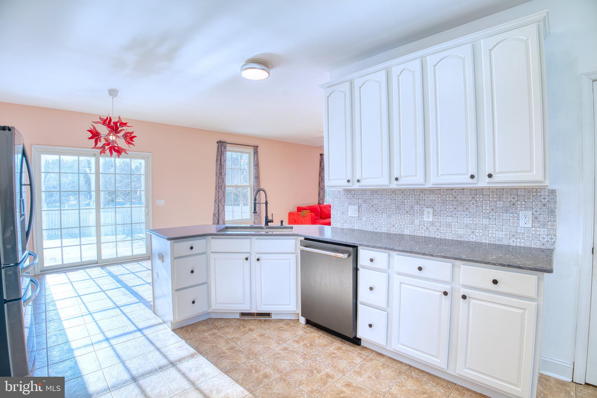 2412 Midstate Road Felton, DE 19943 - Photo 19 of 93 a kitchen with granite countertop a sink cabinets and window
