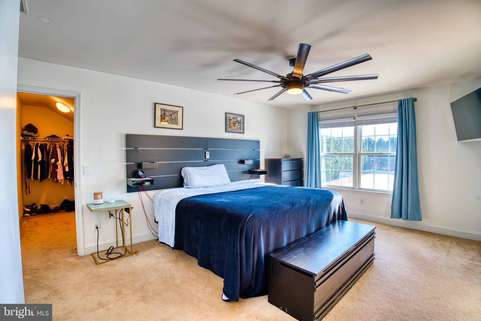 2412 Midstate Road Felton, DE 19943 - Photo 44 of 93 a bedroom with a bed and a chandelier