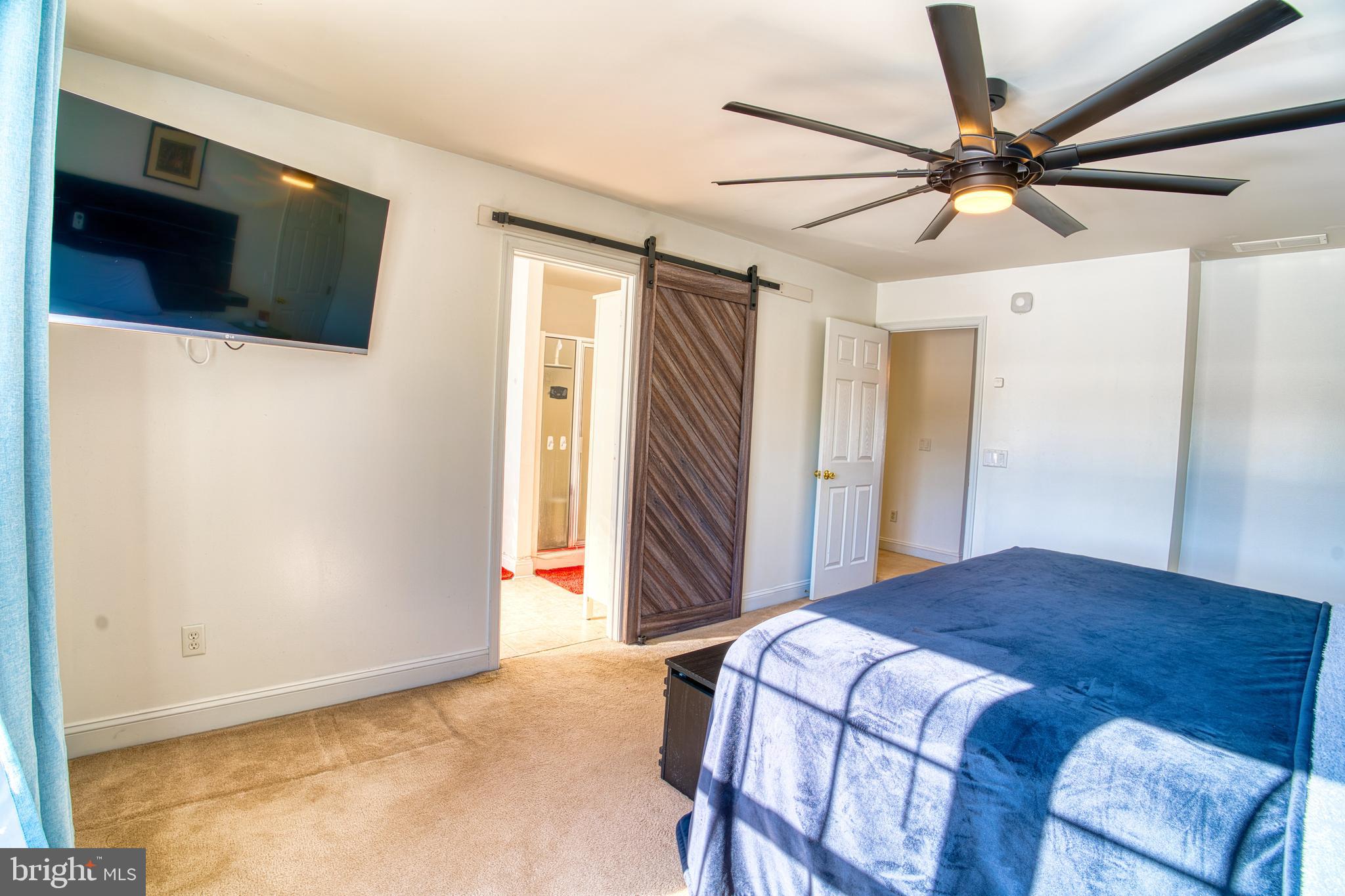 2412 Midstate Road Felton, DE 19943 - Photo 48 of 93 a bedroom with a bed and a flat screen tv